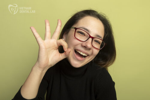 A smiling patient with a restored implant showing confidence